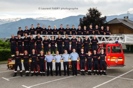 Photographe événementiel pour un centre de secours en Savoie : Photo de groupe du centre de secours devant un véhicule de grande échelle