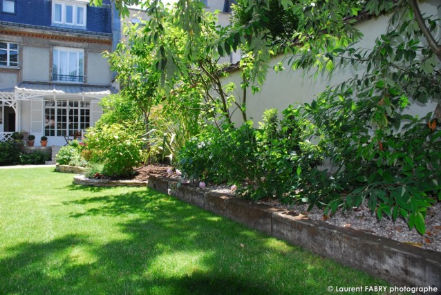 Photographe architecte paysagiste : un peu d'ombre au fond du jardin, près des massifs