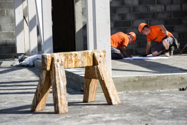 photographe de chantier à Aix-les-bains : deux ouvriers consultent un plan posé sur le sol